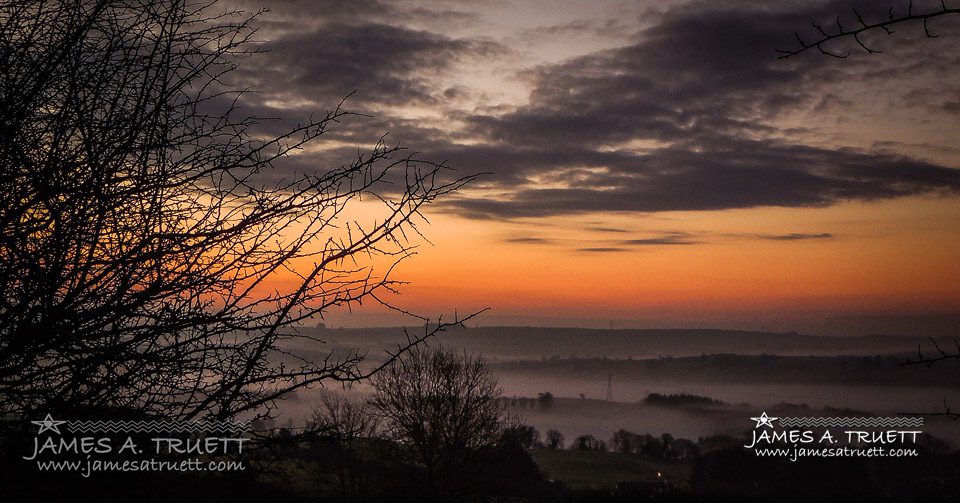 Sunrise with and Irish Mist over a valley in County Clare.